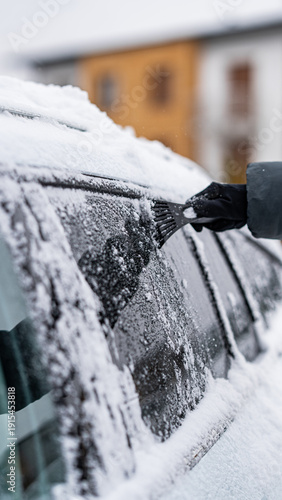 Scraping Ice and Snow from Car Windshield on a Cold Winter Morning