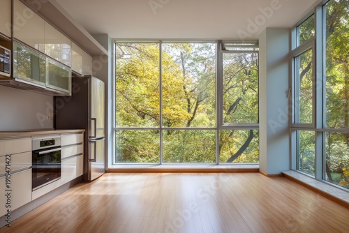 Contemporary kitchen space featuring expansive window views of lush, sunlit foliage