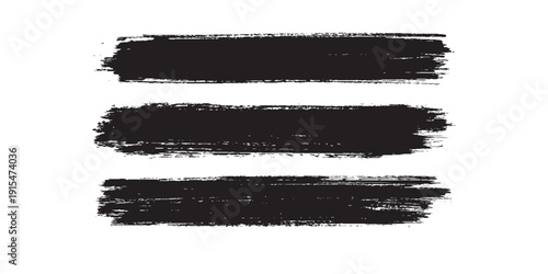фотографія Three Black Brush Strokes on a White Background.