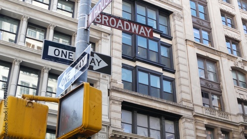 New York City Broadway street sign in Lower Manhattan, United States. Urban road sign in american city. Traffic sign in NYC USA. Building architecture in West Village district near Soho. One way arrow