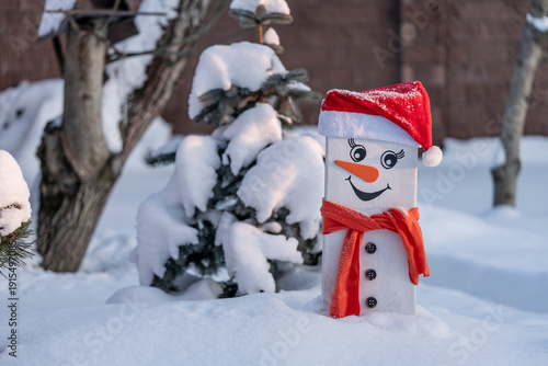 Smiling Wooden Snowman in Sunny Winter Garden