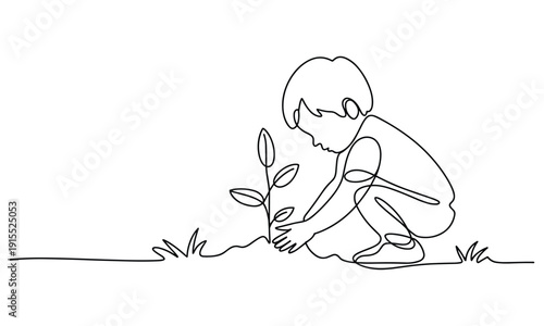 Child planting a small sapling tree on a grassy ground