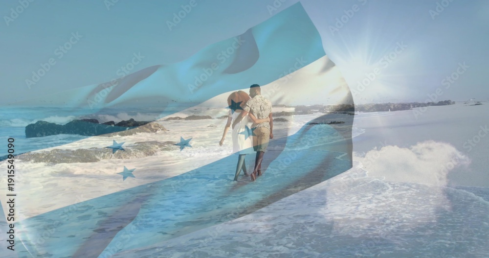 Obraz premium Walking couple wearing sundress and patterned shirt along wet sand to horizon, flag overlay tinting