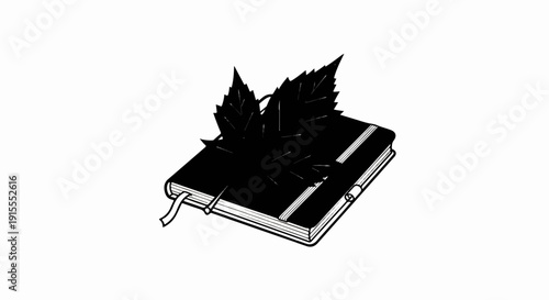 Black notebook with a ribbon marker and two prominent leaves