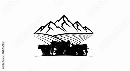 Black silhouette of cows grazing in a field with mountains above