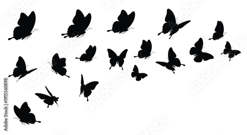 A swarm of black butterflies in flight against a white background