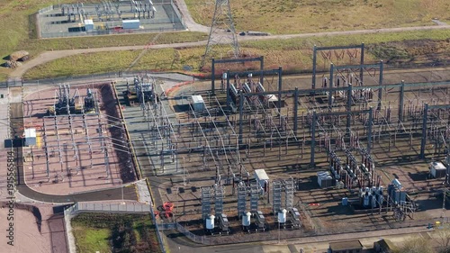 The Great Grid Upgrade aerial view of Sundon Supergrid substation near Luton UK featuring 400kV transformers and high-voltage pylons.