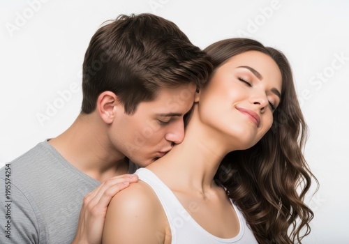 Young couple sharing an intimate moment with a gentle kiss on the neck