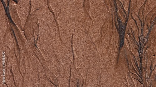Magical with Black Sand Beaches on multicolored Hormuz Island, Iran. The dark sand from heavy minerals such as hematite, ilmenite, and magnetite, creating striking textures along the shoreline.