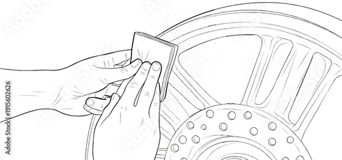 Hands carefully sand a motorcycle wheel rim with a square abrasive pad