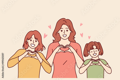Loving mother and daughters share a heartwarming moment, forming hearts with their hands.