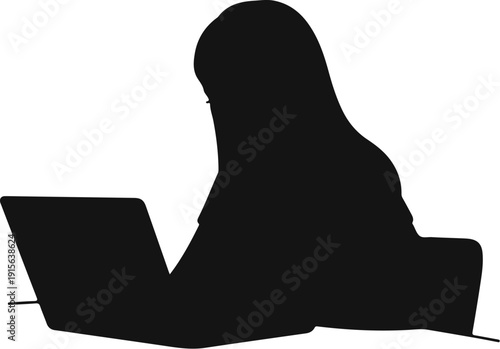 Silhouette of a person wearing a headscarf using a laptop at a desk