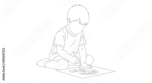 A black and white line drawing depicts a young boy seated on the floor intently drawing on a paper with a pencil