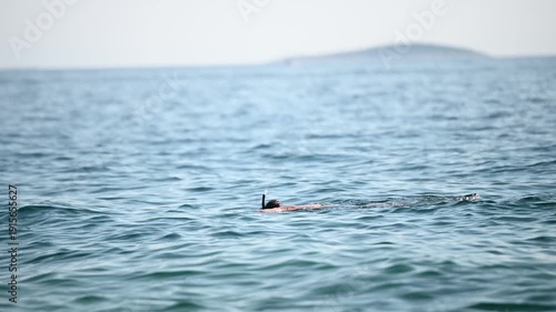 Man snorkeling in the sea. A tourist dives with mask and  snorkel.