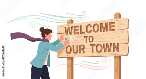 A Person Freshening Up A Wooden Welcome Sign In Windy Conditions