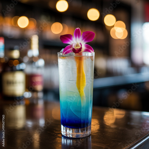 A vibrant cocktail with a flower garnish on a bar counter.
