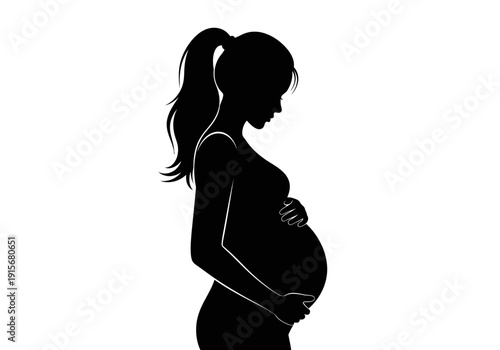 A striking silhouette depicts a pregnant woman in profile gently cradling her baby bump high quality