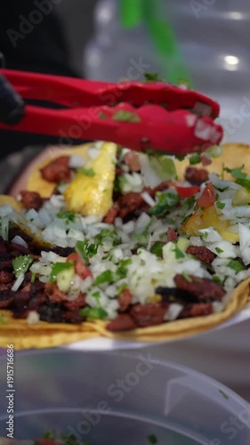 Slow Motion Salsa Verde Poured Over Al Pastor Tacos – Vertical Close Up Street Food in Southern California