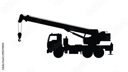 Silhouette of a crane truck with extended boom and hook