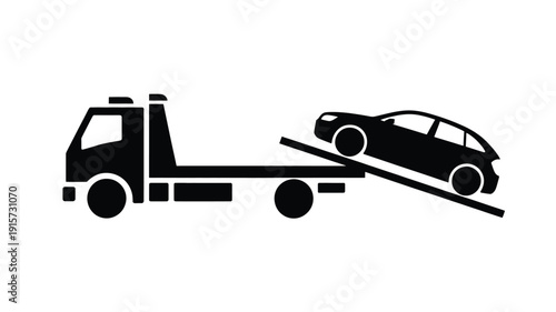 Tow truck loading car on flatbed