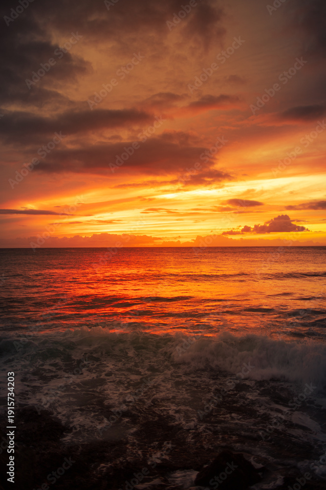 Fototapeta premium Dramatic Fiery Ocean Sunset with Waves and Colorful Cloudy Sky