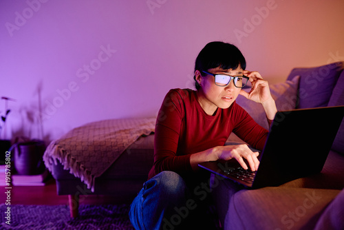 Tableau sur toile Woman feeling stressed or concentrated while working late at night on a laptop f