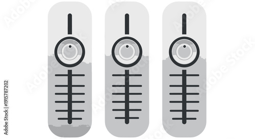 Three identical gray remote controls with black buttons and circular dials.