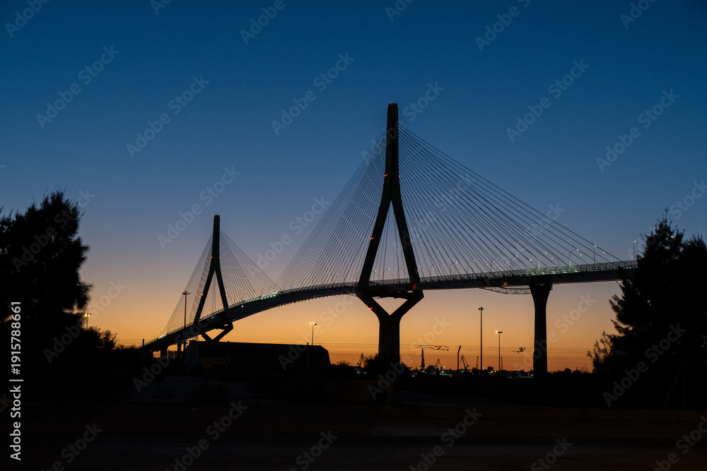 Obraz premium Cable-stayed bridge silhouette at dusk, Cádiz, Spain