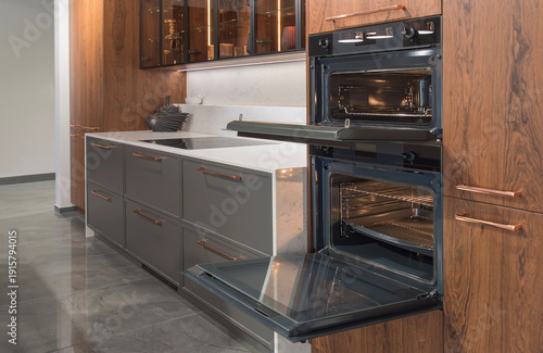 Quadro su tela Modern luxury kitchen with built-in ovens and induction cooktop