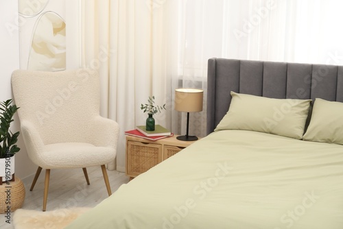 Comfortable bed with stylish linens at home