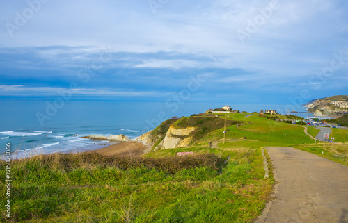 Rocky coastline and sandy beach with cliffs and ocean waves. High quality photo