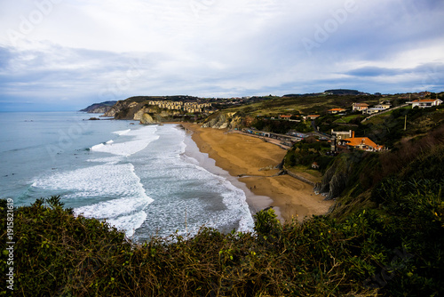 Rocky coastline and sandy beach with cliffs and ocean waves. High quality photo