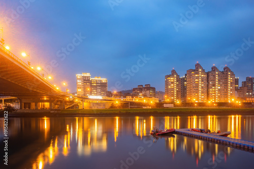 Wallpaper Mural City lights reflect on calm river at twilight. Torontodigital.ca