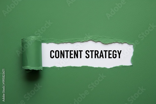 green textured paper ripped open to reveal white paper beneath showing bold black text ‘CONTENT STRATEGY’