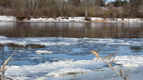 Narew River in winter, close-up of floating ice floes.
