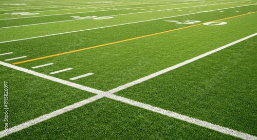 Close-up of a vibrant green sports field with yard lines, perspective shot