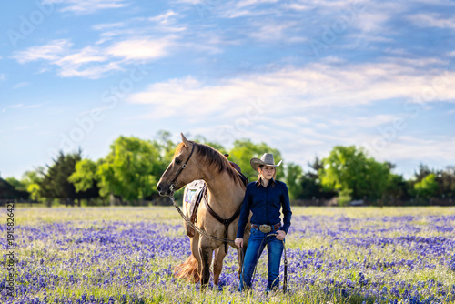 Tablou pe pânză Texas Cowgirl with Dun Quarter Horse in Texas Bluebonnets