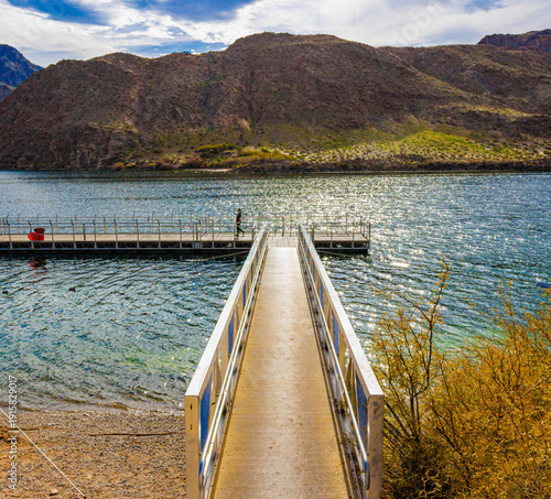 Female Tourist Walking on Fishing Pier on The Colorado River at Willow Beach Marina, Lake Mead National Recreation Area, Arizona, USA