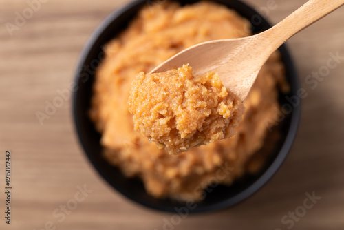 Принти на полотні Close up of scooping traditional Japanese miso paste from a black bowl with a wo