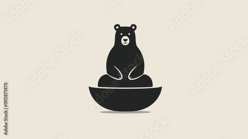 Black bear sitting serenely in a curved bowl, isolated against a muted, neutral background