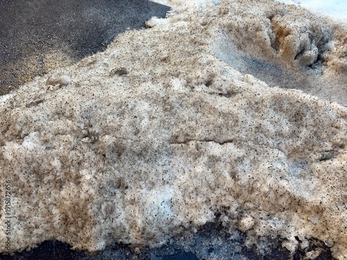 Melting Snow Piles in Parking Lot Showing Clean and Dirty Snow Contrast