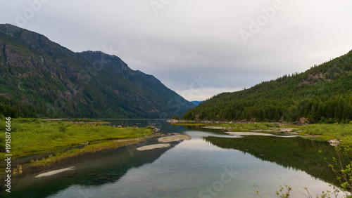 The sill waters of Buttle Lake reflects the forested shoreline in Strathcona Provincial Park.