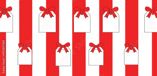 A festive pattern of red ribbons and white gift tags on a striped background viewed from directly above