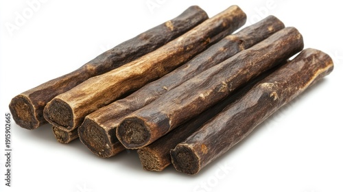 Close-up shot of a stack of dried, elongated, brown treats, ideal for pets, on a white background