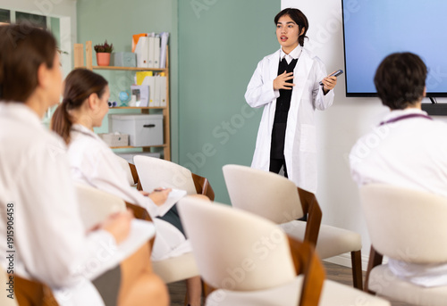 Canvas Print Confident young malaysian female medical students with remote control confidentl