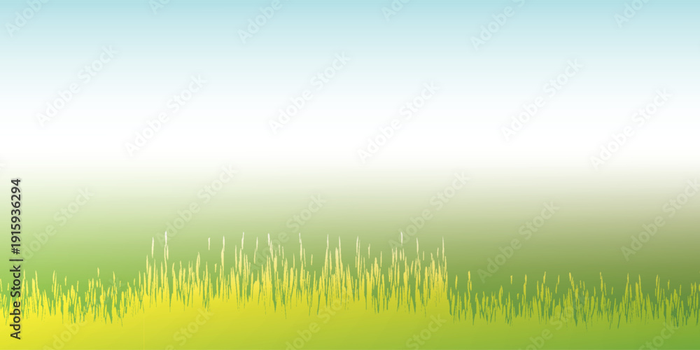 Fototapeta premium Vibrant green grass field with a clear blue sky background.