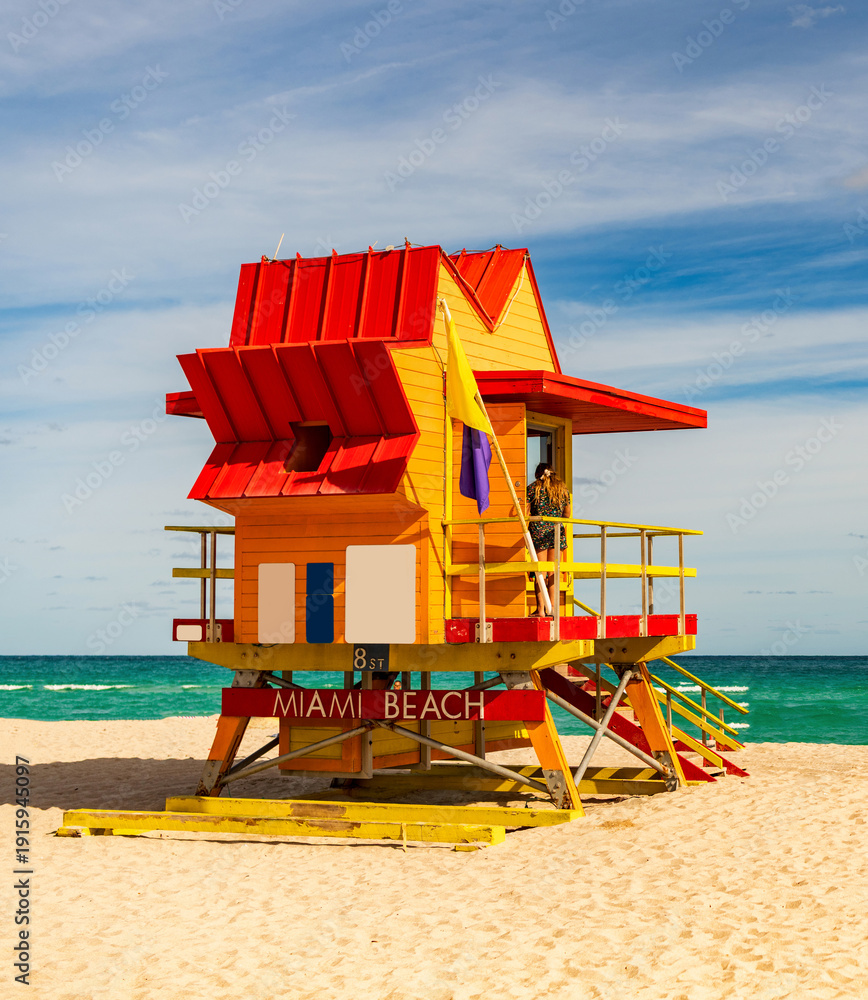 Fototapeta premium Miami Beach. Lifeguard tower on South Miami Beach. Miami Beach coastline. Famous Beach lifeguard. Travel to Miami. Art Deco lifeguard on Miamis shoreline. Jetty lifeguard tower.