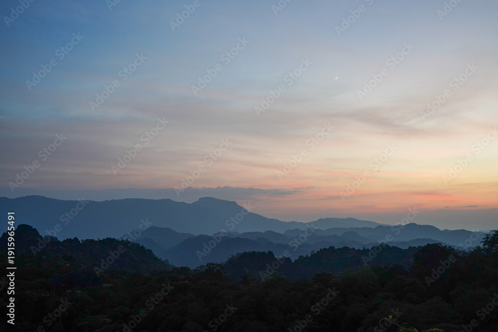Fototapeta premium Sunset Over Layered Karst Mountains from Limestone Forest Viewpoint, Thakhek Loop, Laos