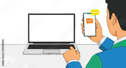 Man using smartphone with message notification next to laptop. Digital communication concept.