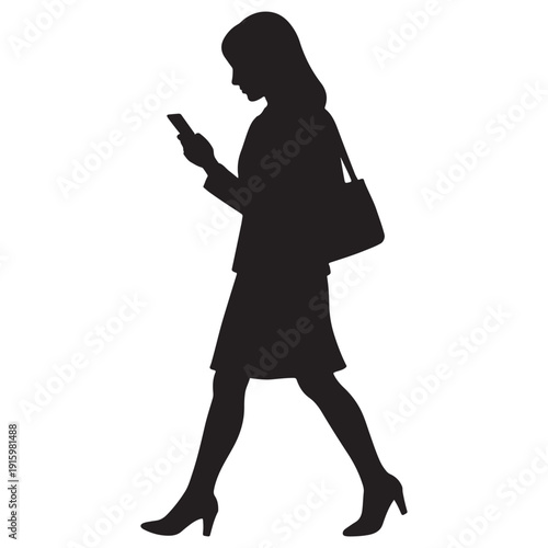 Silhouette of a woman walking while looking at her smartphone, carrying a handbag.